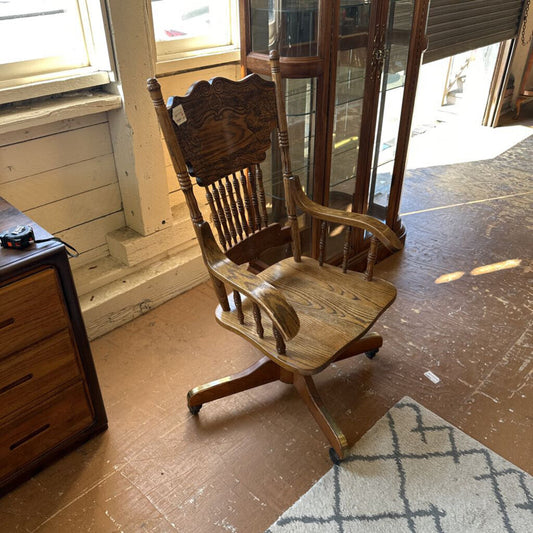 Wooden rocking chair in a room with wooden floor and furniture.