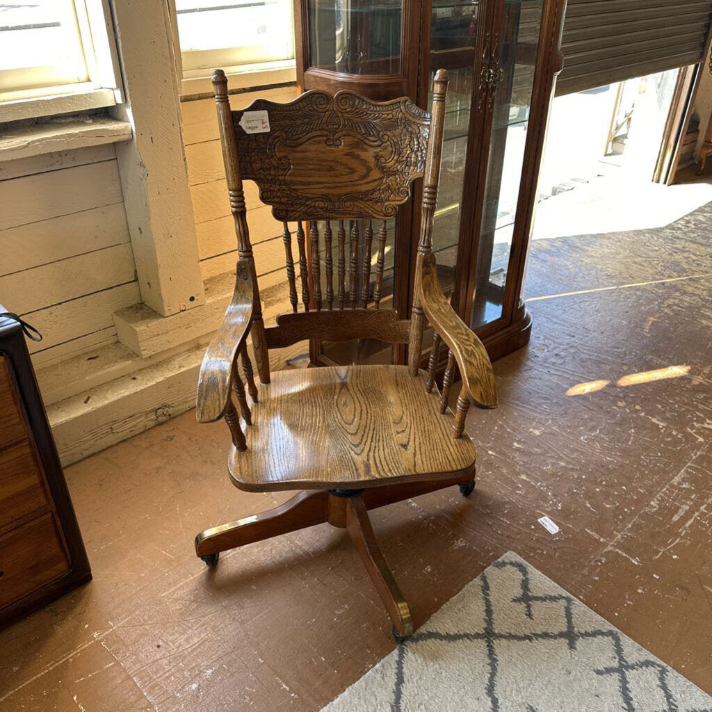 Wooden rocking chair on a wooden floor with a blurred background