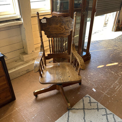 Wooden rocking chair on a wooden floor with a blurred background