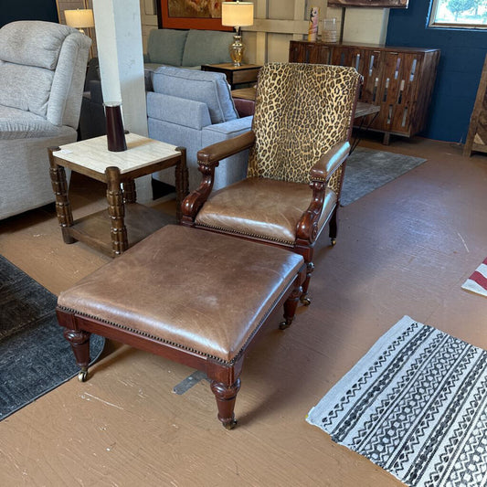 Brown leather chair with leopard print backrest in a room with furniture and decor.