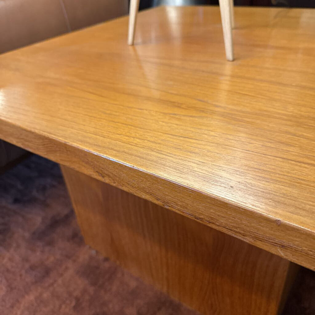 Close-up of a wooden table surface with a blurred background