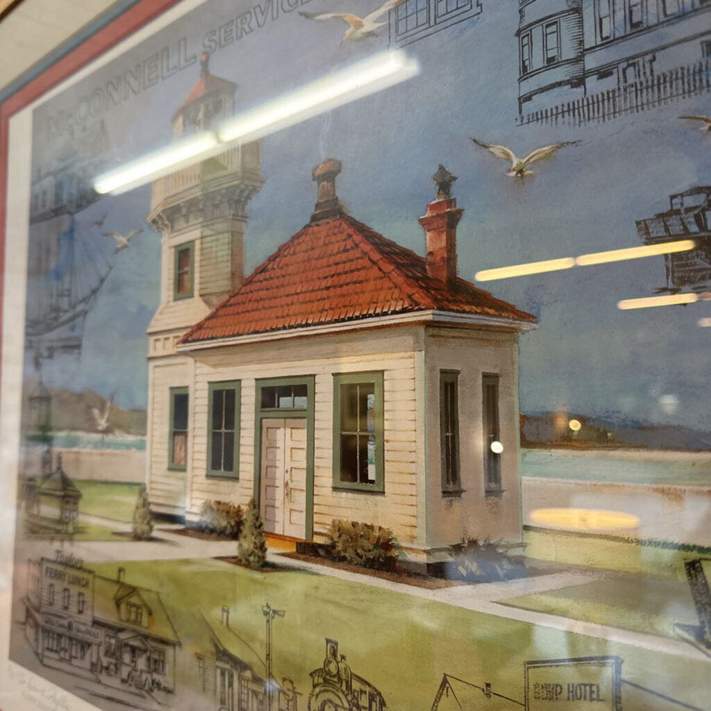 Decorative mural of a lighthouse and coastal scene with a building reflection.
