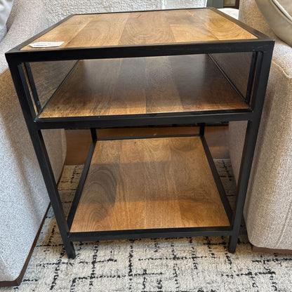 Wooden side table with metal frame against a neutral background