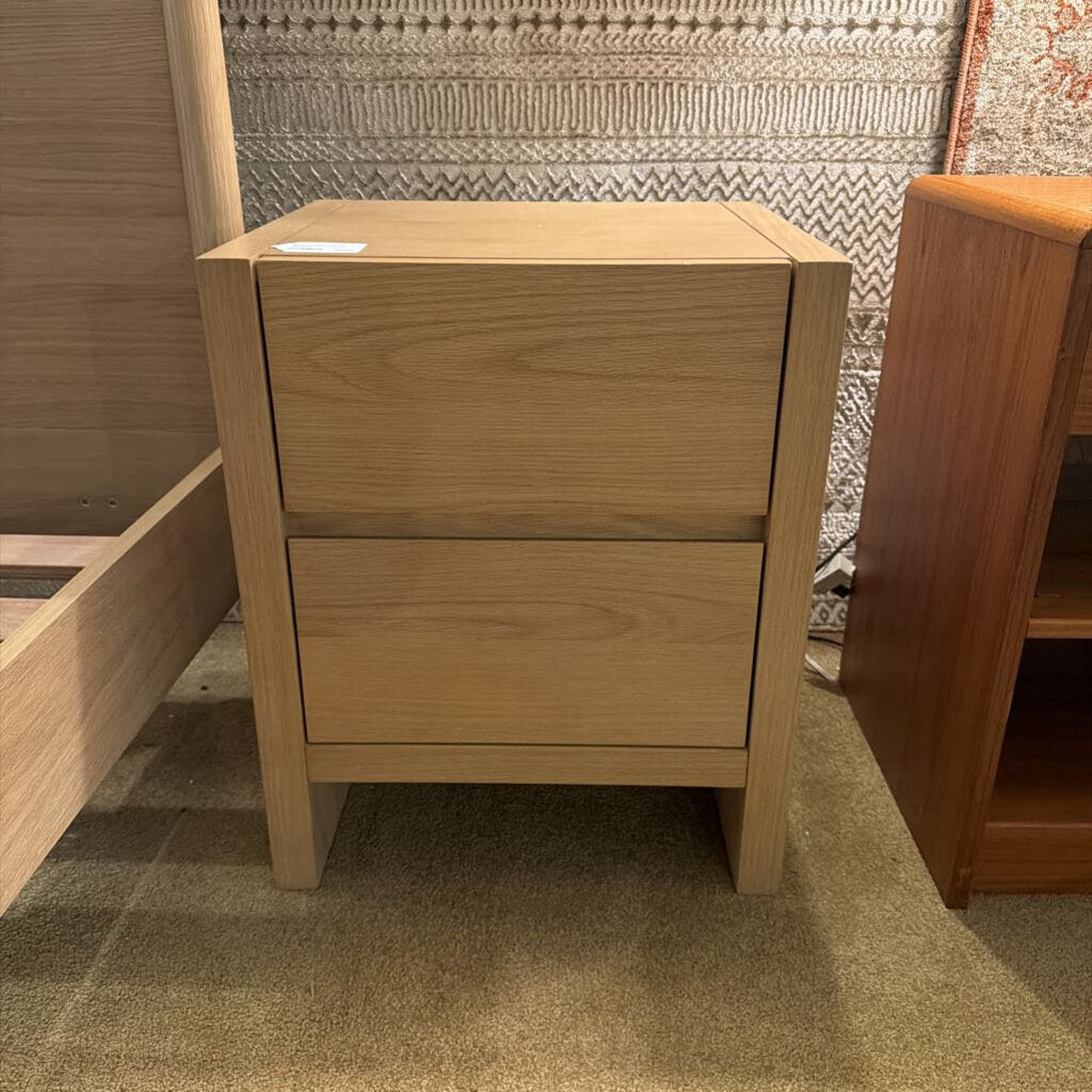 Wooden nightstand with two drawers in a room setting