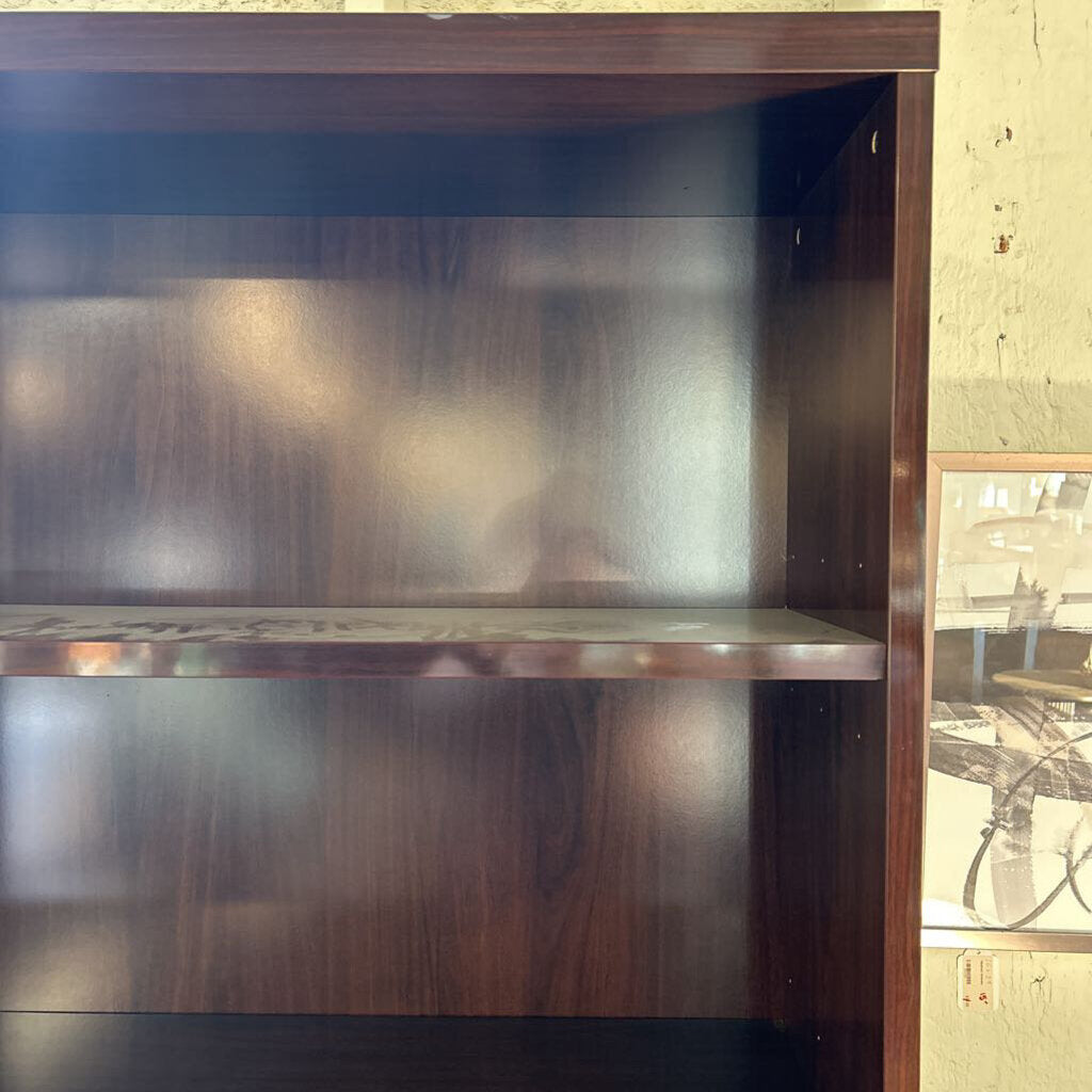 Wooden bookshelf with a reflective surface