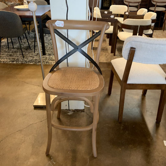Wooden chair with a woven seat in a furniture store setting