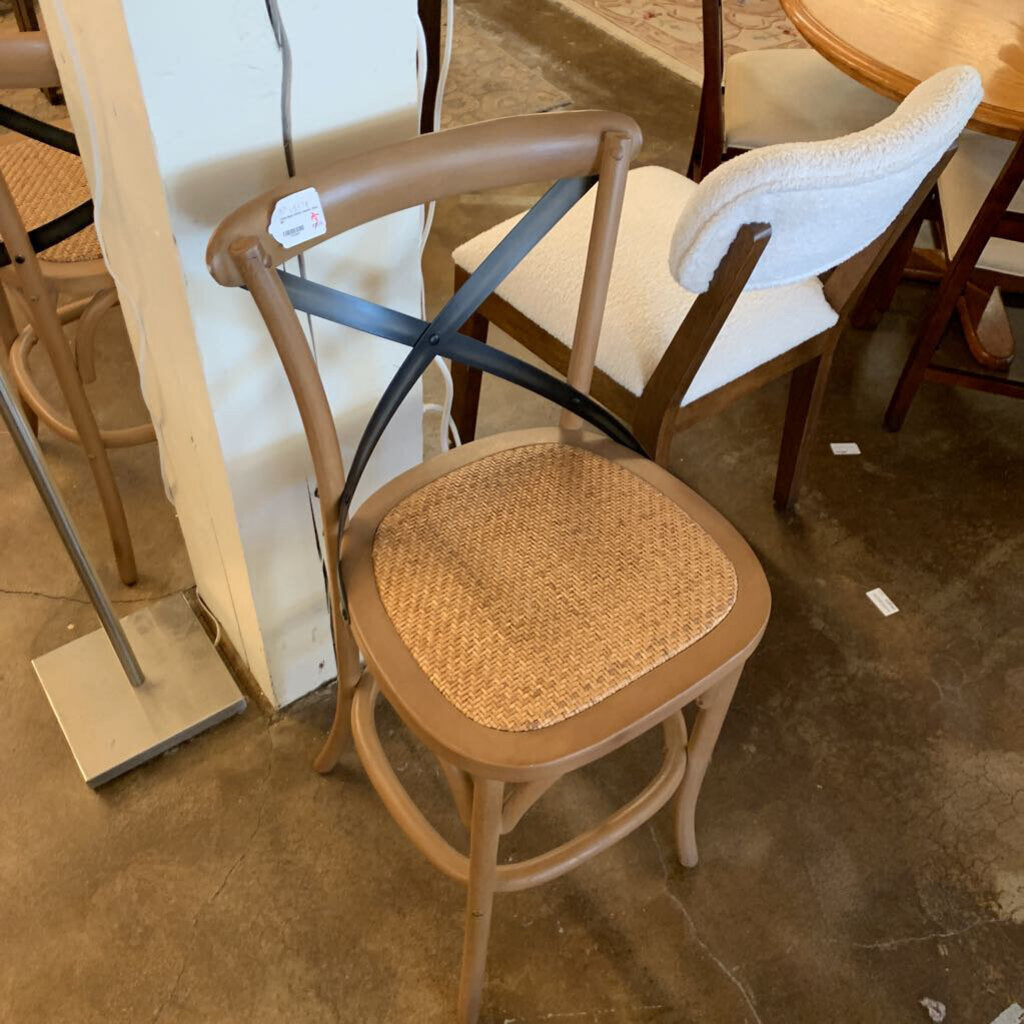 Wooden chair with wicker seat in a store setting