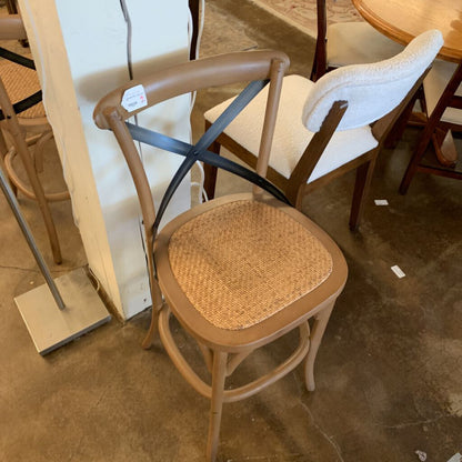 Wooden chair with wicker seat in a store setting