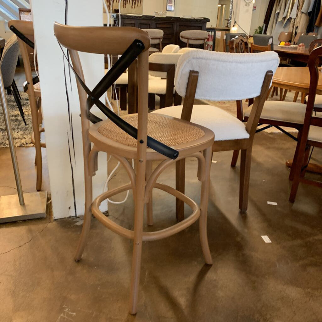 Wooden bar stools with wicker seats in a store setting