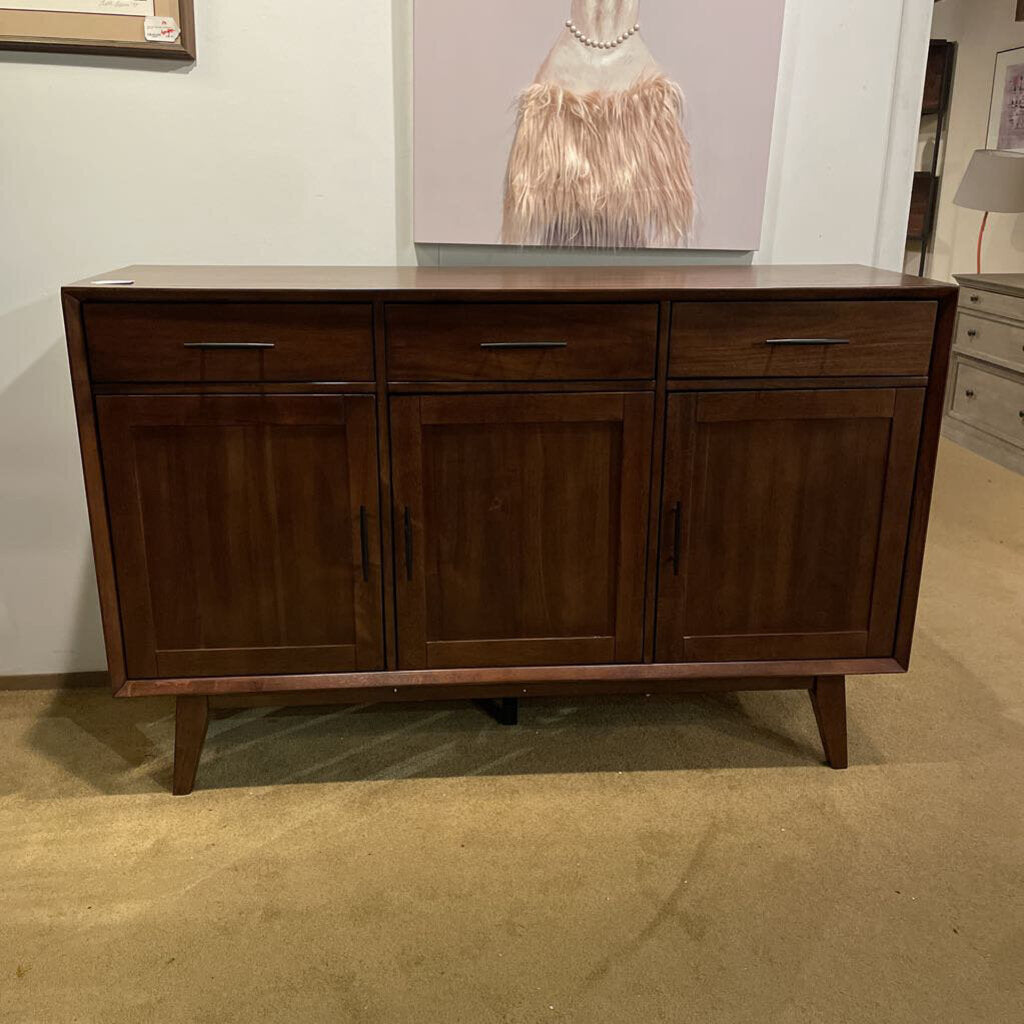 Wooden sideboard in a room with a painting on the wall
