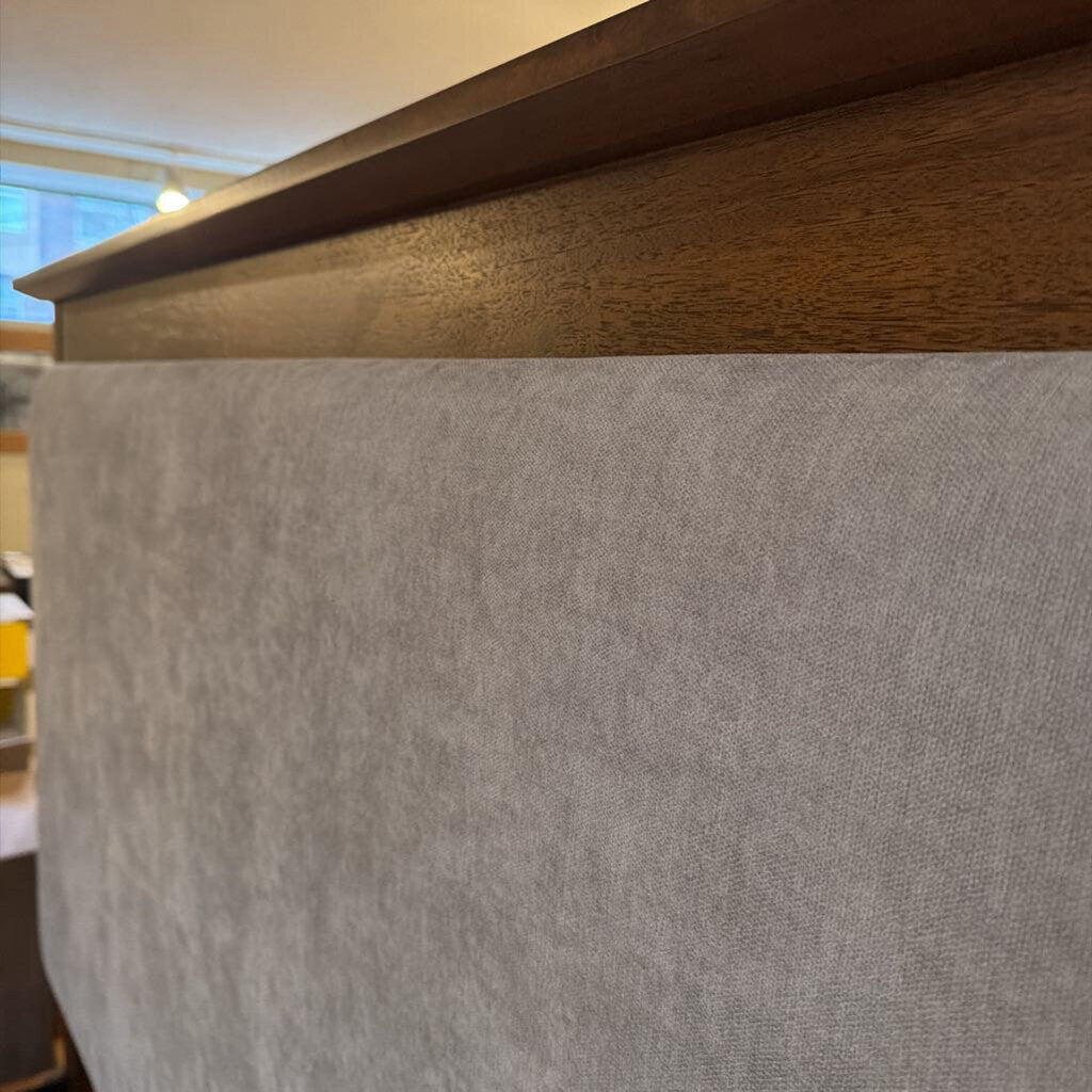 Close-up of a wooden surface with a gray fabric covering