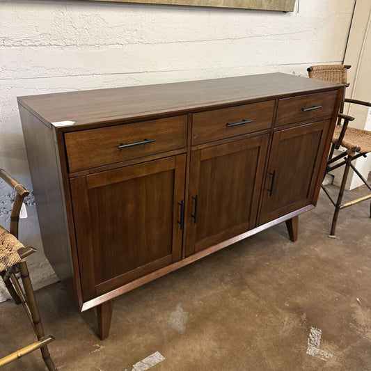Wooden sideboard with drawers and doors in a room setting