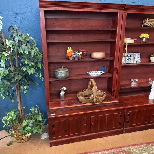 Wooden bookshelf with decorative items against a blue wall