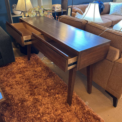 Wooden desk with drawers in a living room setting