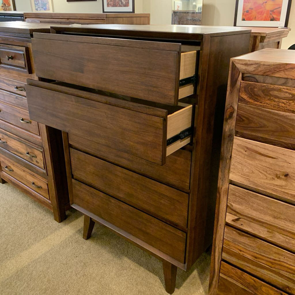 Wooden dresser with multiple drawers in a room setting
