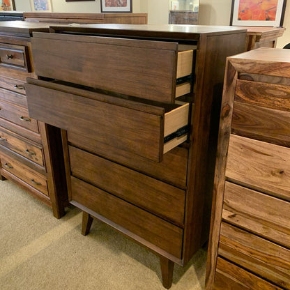 Wooden dresser with multiple drawers in a room setting
