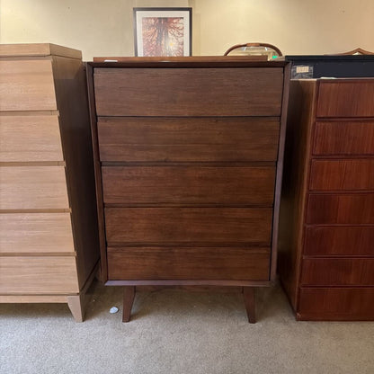 Wooden dresser with multiple drawers in a room setting