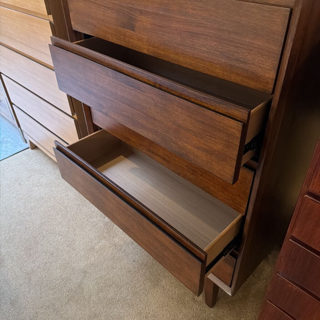 Wooden dresser with open drawers on a carpeted floor