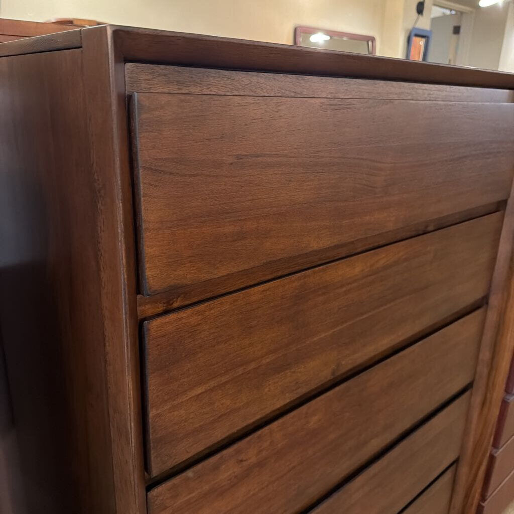 Close-up of a wooden dresser with three drawers.