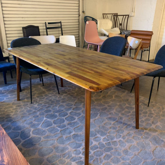 Wooden dining table with chairs in a room with patterned floor