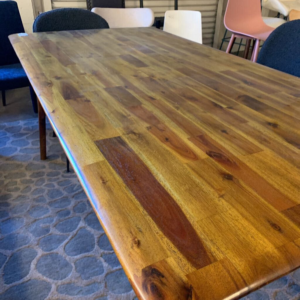 Wooden dining table with chairs in a room setting