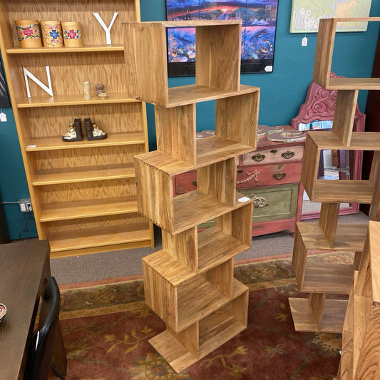 Wooden bookshelves in a room with a television and decorative items.