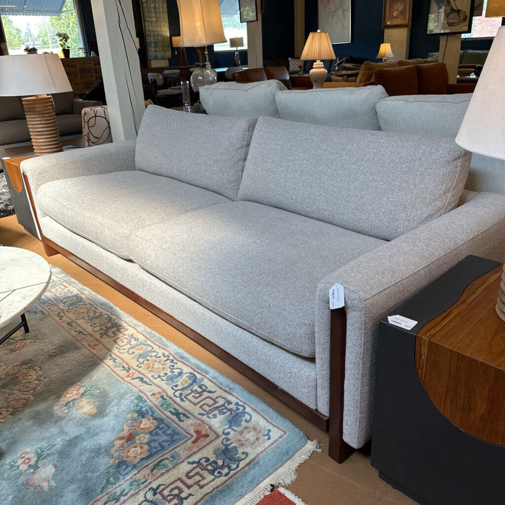 Gray sofa in a room with wooden flooring and decorative elements