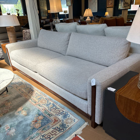 Gray sofa in a room with wooden flooring and decorative elements