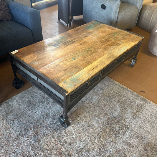 Wooden coffee table with metal legs in a living room setting