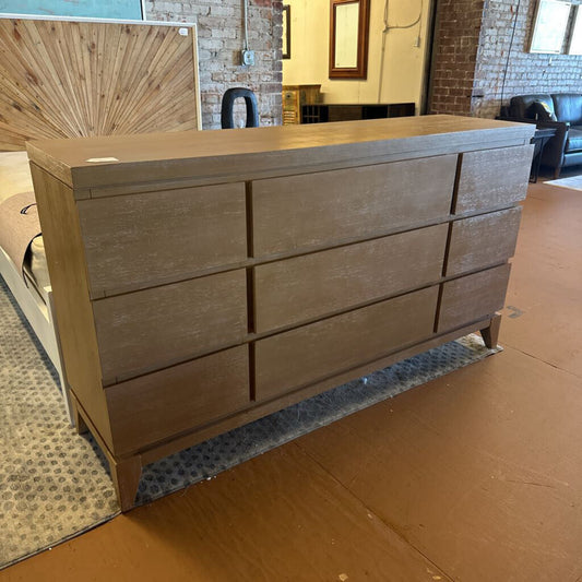 Wooden dresser on a cardboard box with a room in the background
