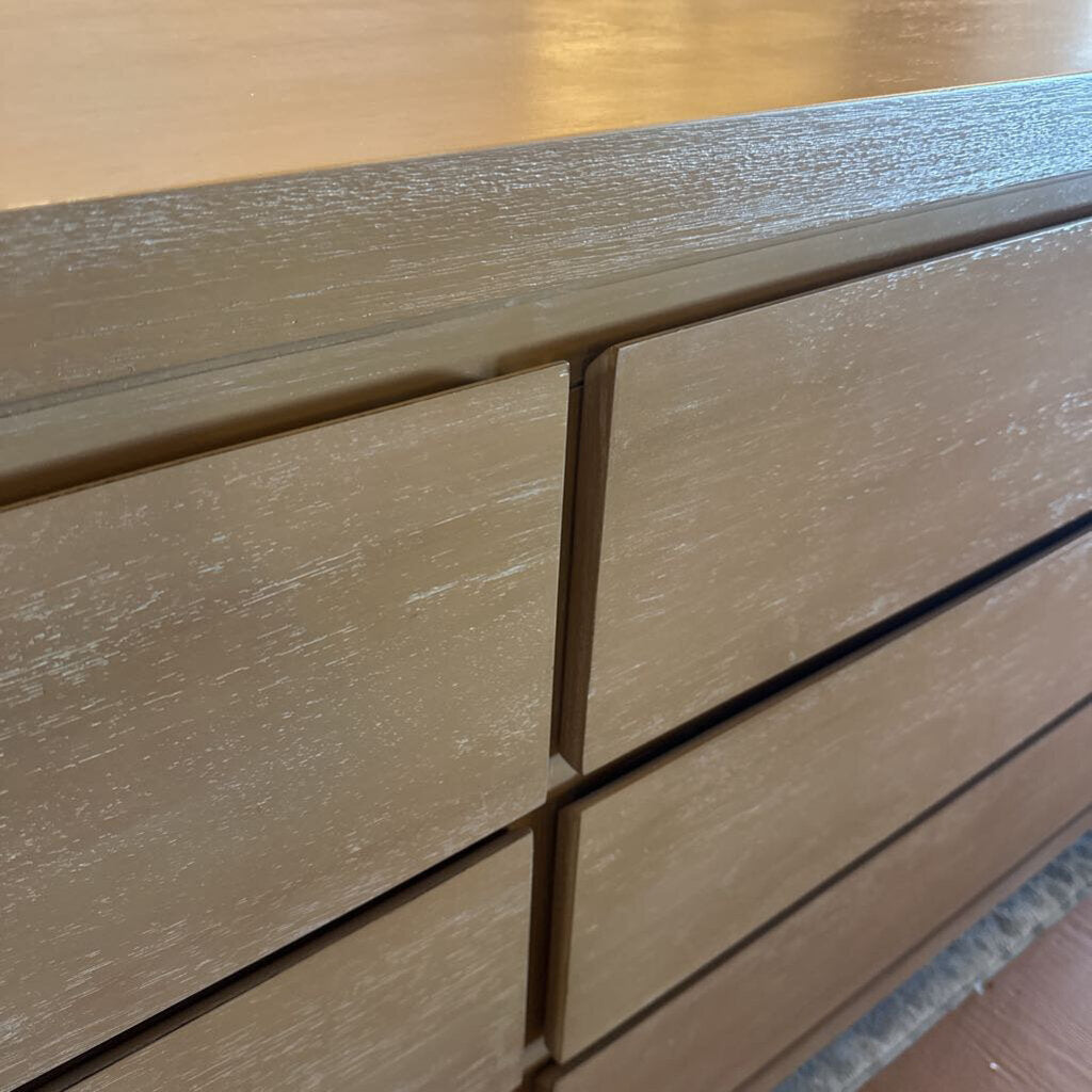 Close-up of a wooden drawer with a visible grain pattern