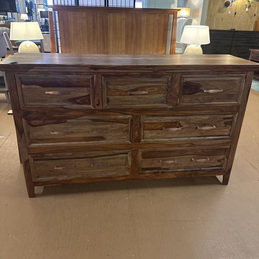 Wooden dresser with multiple drawers in a store setting