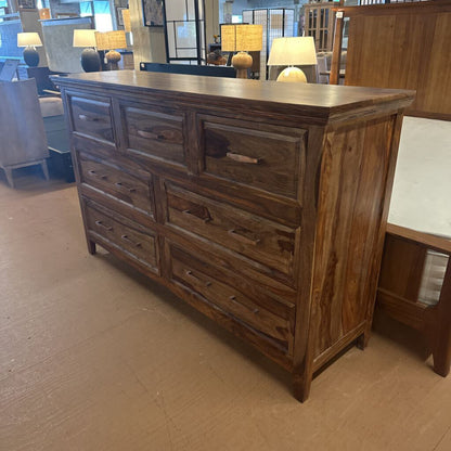 Wooden dresser with multiple drawers in a room setting