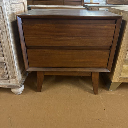 Wooden dresser with two drawers on a brown floor