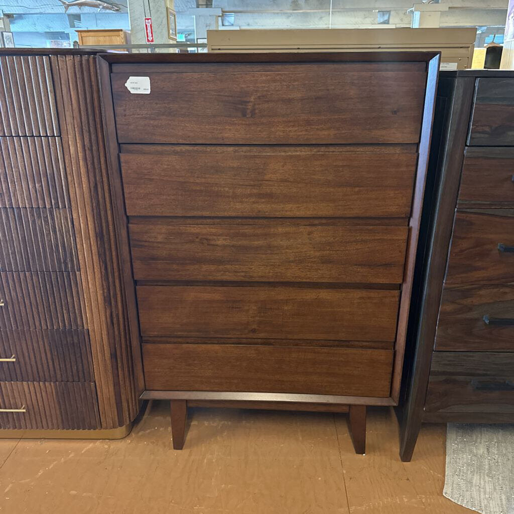 Wooden dresser with multiple drawers in a store setting