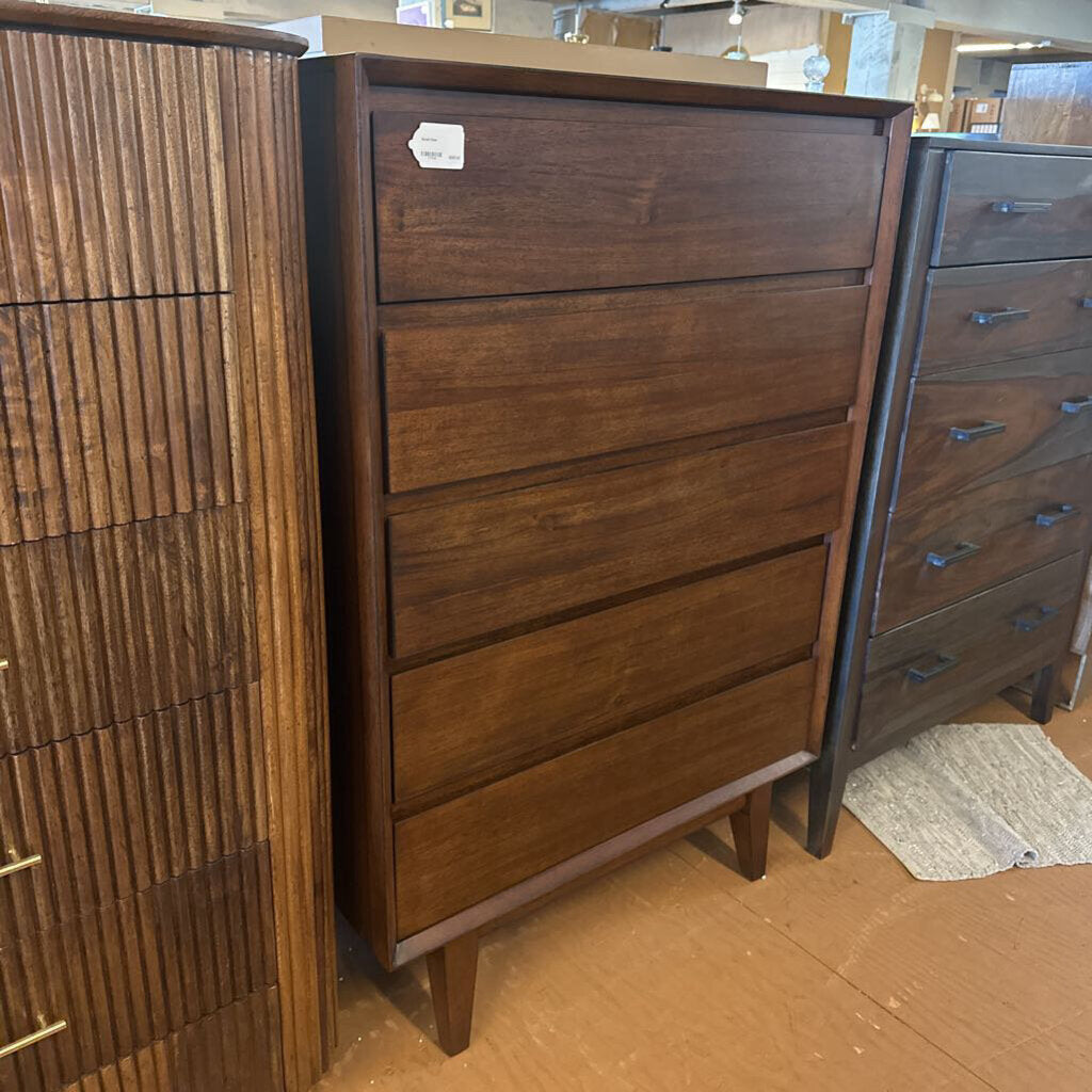 Wooden dresser with multiple drawers in a store setting
