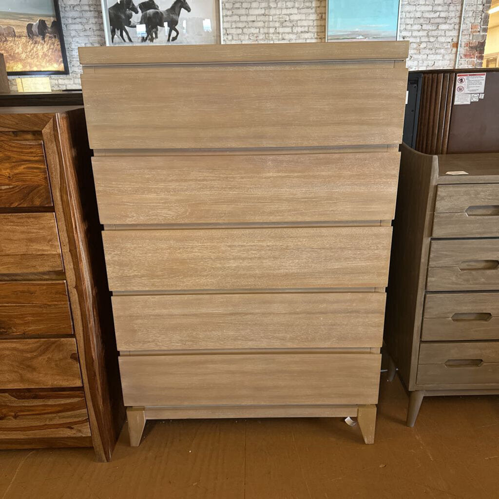 Wooden dresser with multiple drawers in a store setting
