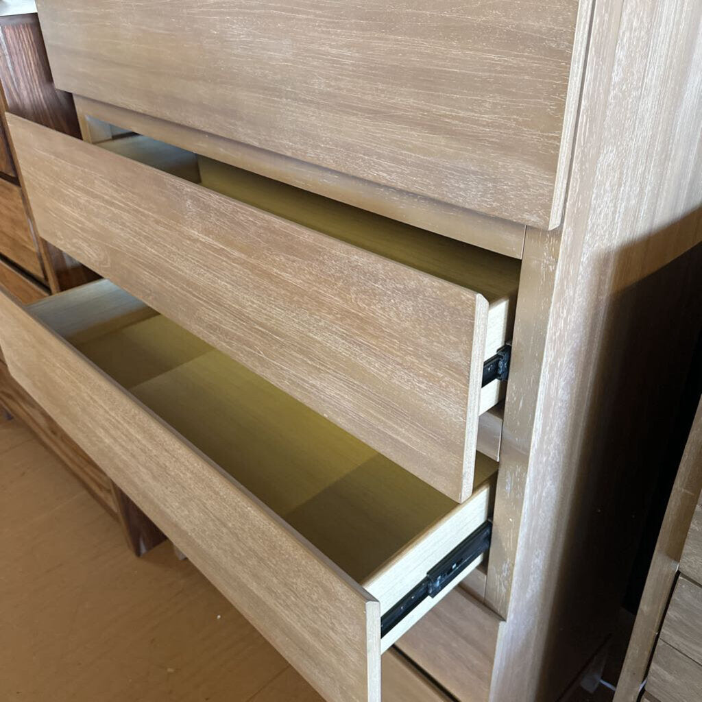 Wooden dresser with open drawer on a wooden floor