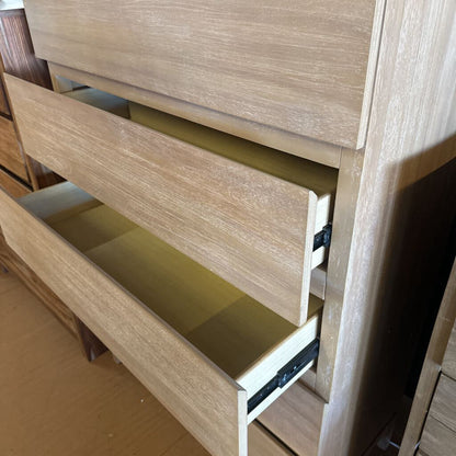 Wooden dresser with open drawer on a wooden floor