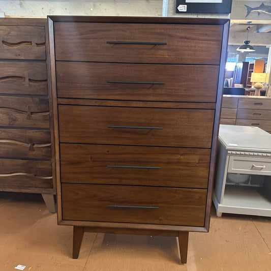 Wooden dresser with multiple drawers in a store setting