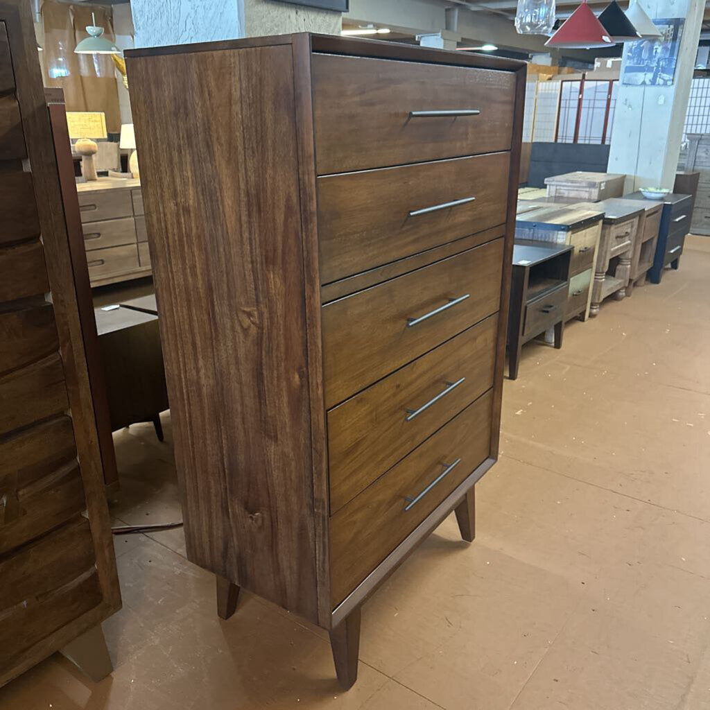 Wooden dresser with multiple drawers in a showroom setting