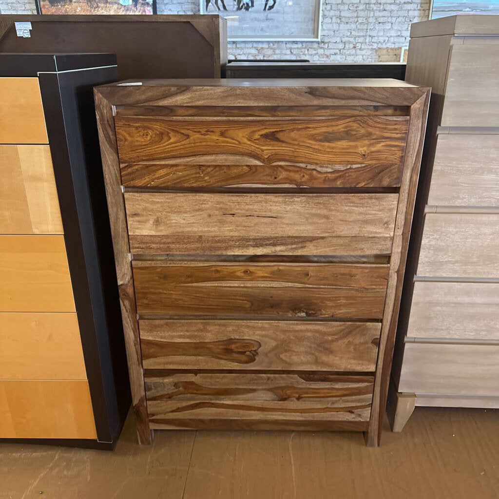 Wooden dresser with multiple drawers in a store setting