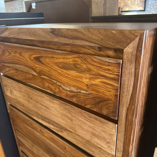 Wooden dresser with a focus on the grain and texture of the wood.