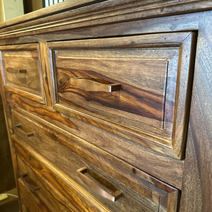 Close-up of a wooden dresser with visible grain and texture.