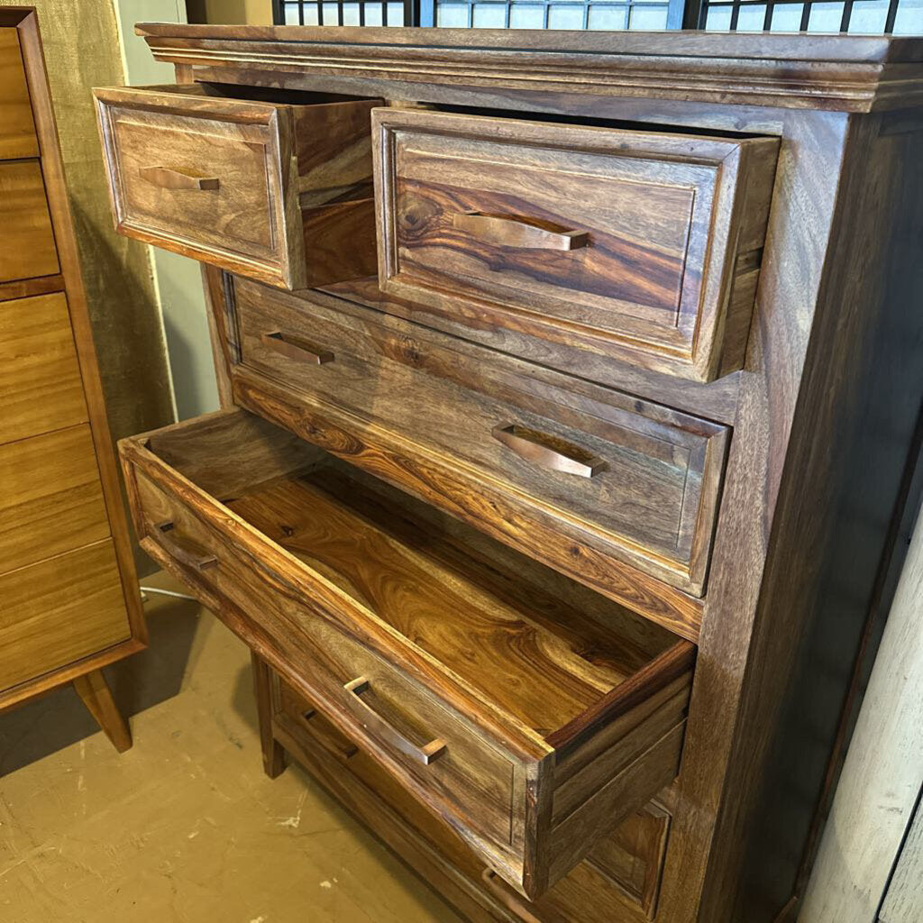 Wooden dresser with multiple drawers in a room setting