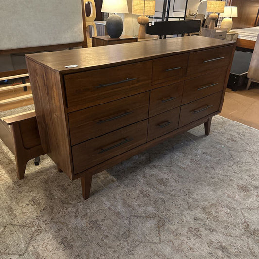 Wooden dresser with multiple drawers in a room setting