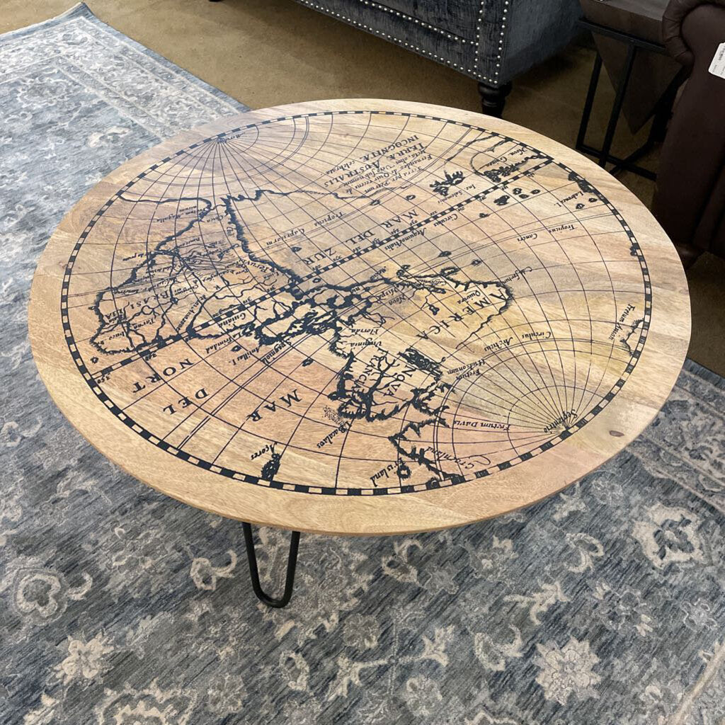 Round wooden table with world map design on a patterned rug