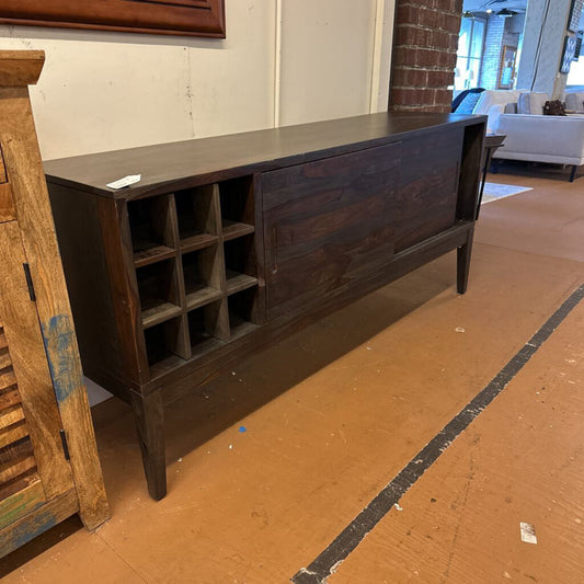 Dark wooden sideboard with open shelves in a room setting