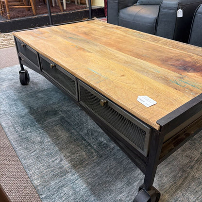 Wooden coffee table with metal frame on a gray rug