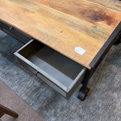 Wooden desk with a metal drawer on a gray carpet
